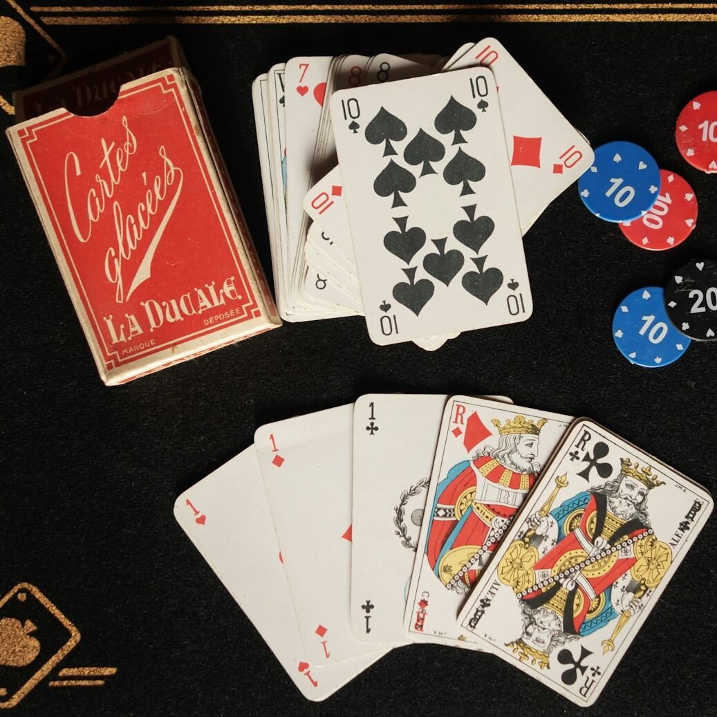 A black table topped with playing cards and chips